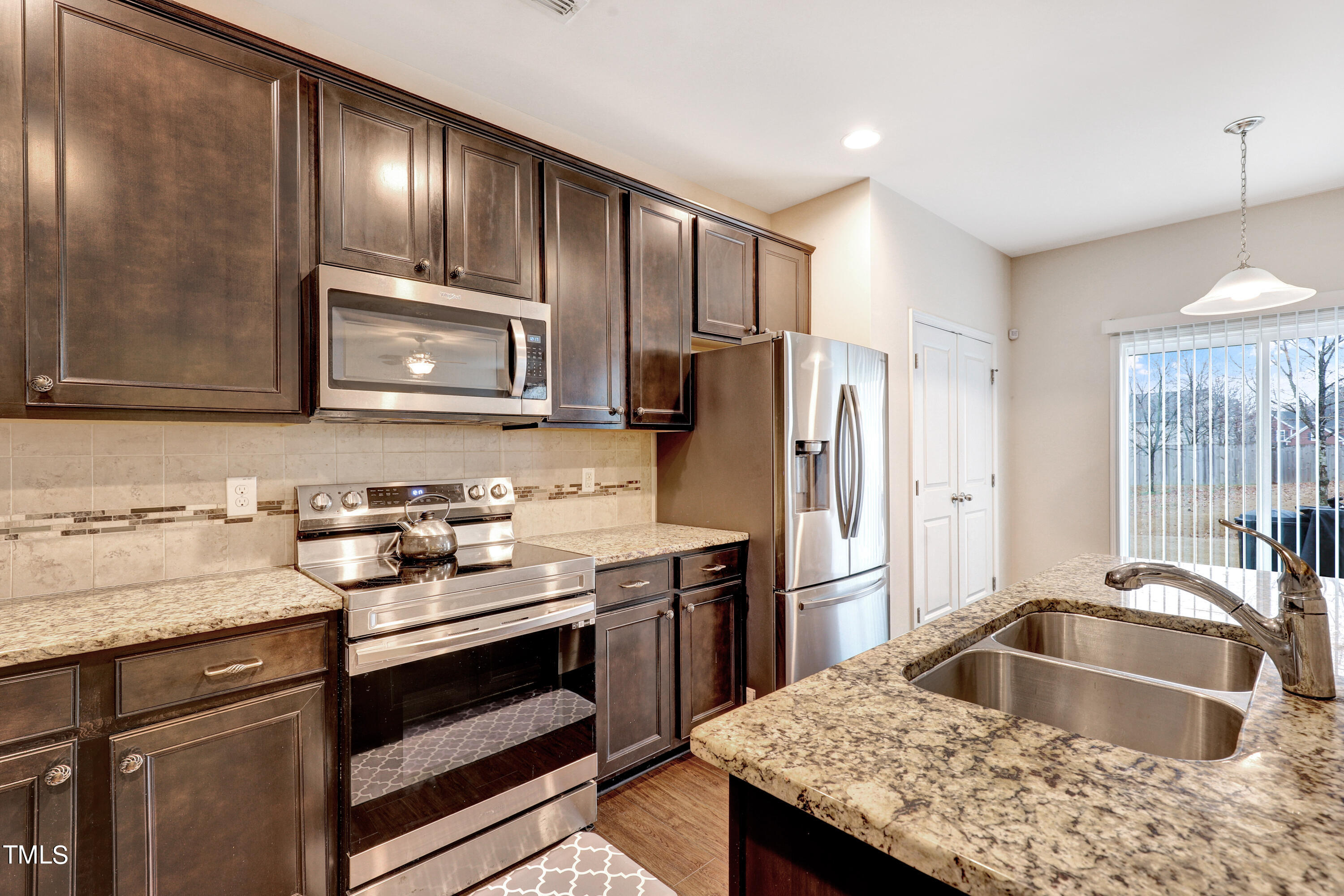 329 Hope Valley Road Knightdale, NC 27545 - Photo 10 of 34 a kitchen with granite countertop a sink cabinets and stainless steel appliances