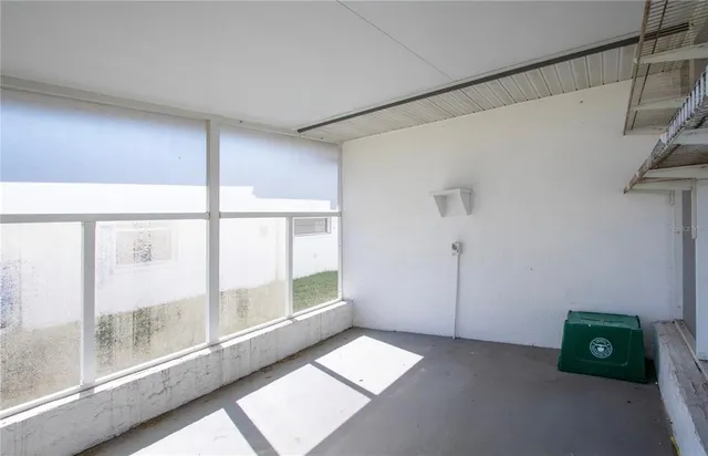 a living room with furniture a wooden floor and a large window