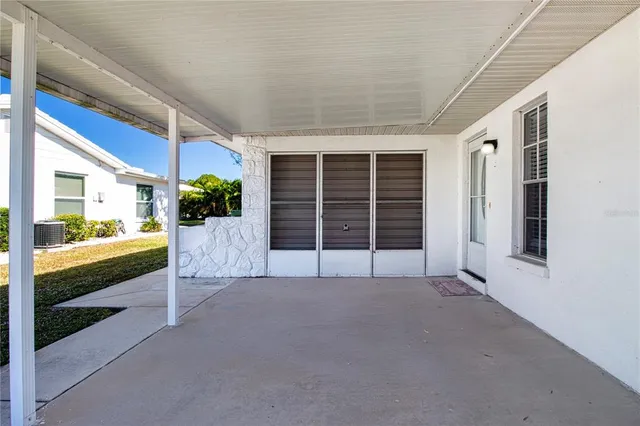 a room with pool table and windows