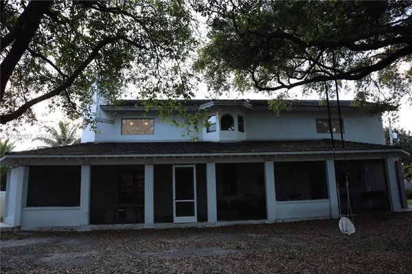 a view of a house with a tree