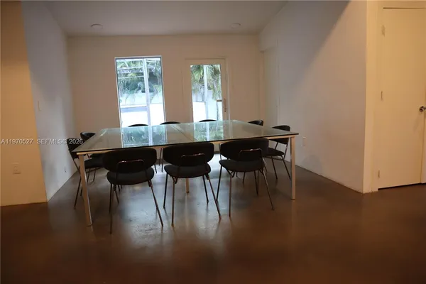 a dining room with furniture and wooden floor