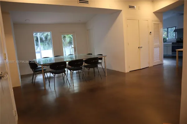 a dining room with furniture and wooden floor