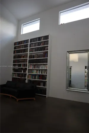 a view of a livingroom with furniture and a window
