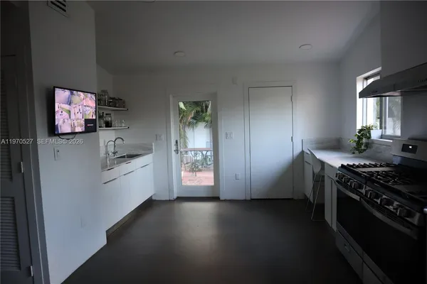 a kitchen with stainless steel appliances a white stove top oven and a refrigerator