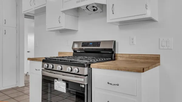 a stove top oven sitting inside of a kitchen