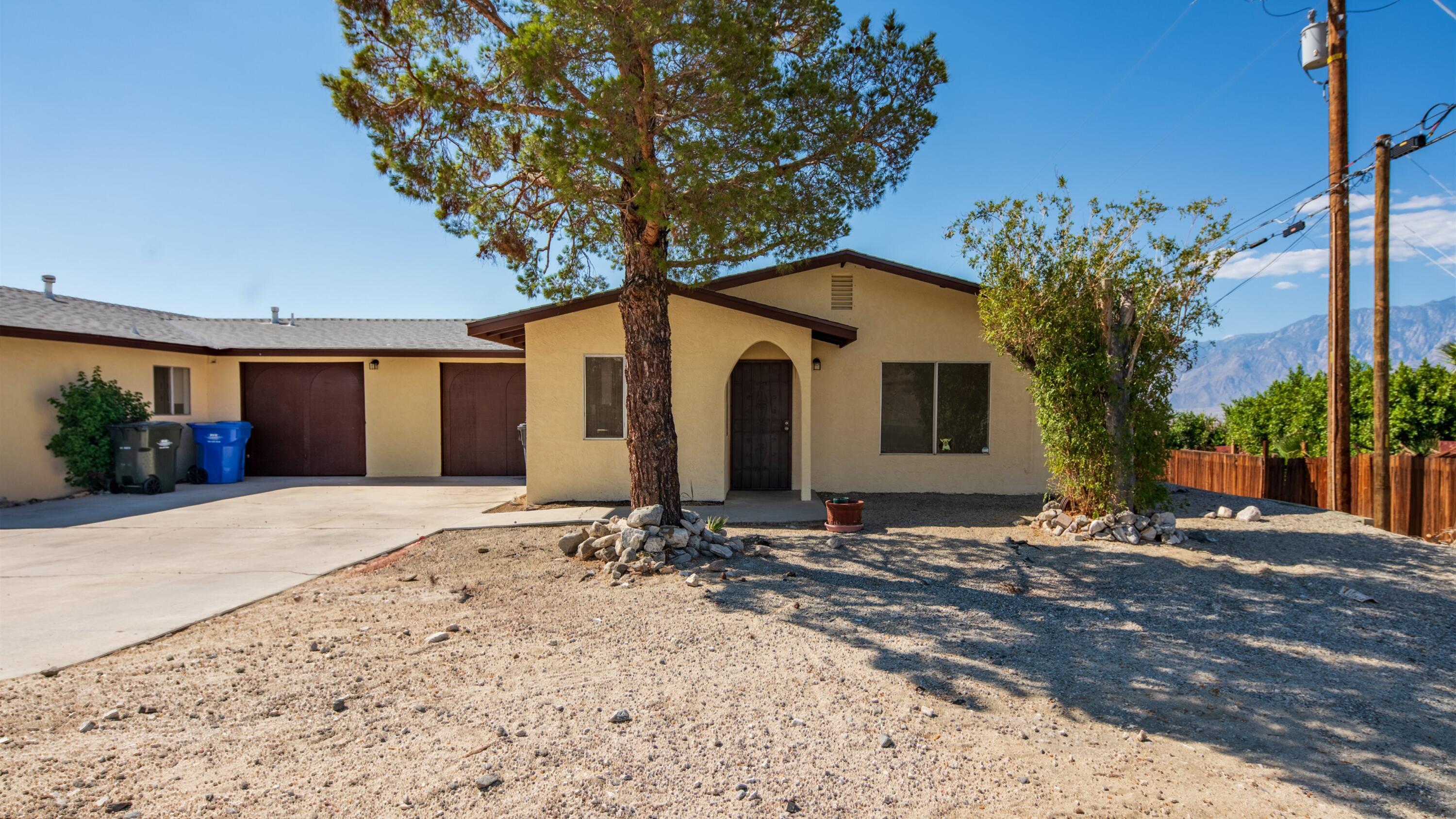 67285 Pierson Boulevard, Unit B Desert Hot Springs, CA 92240 - Photo 4 of 29 a front view of a house with garden