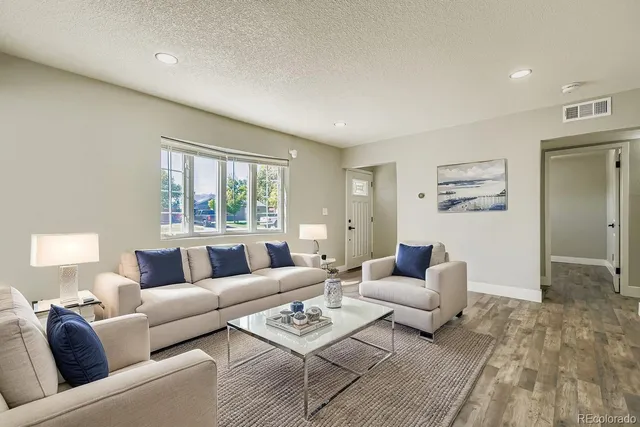 a living room with furniture and a large window