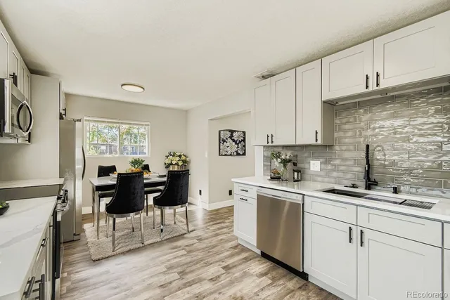 a kitchen with a sink cabinets and wooden floor