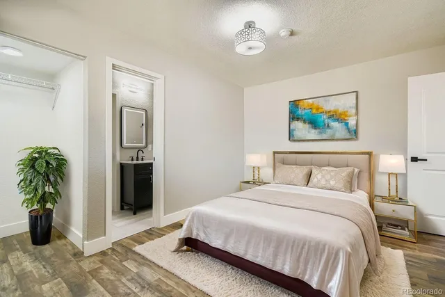 a spacious bedroom with a bed and a view of bathroom