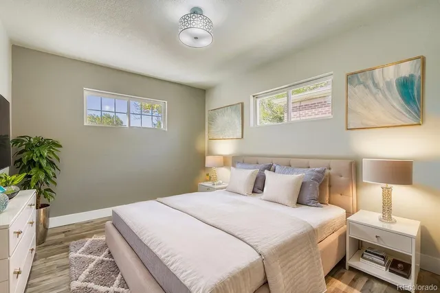 a bedroom with a bed and a potted plant