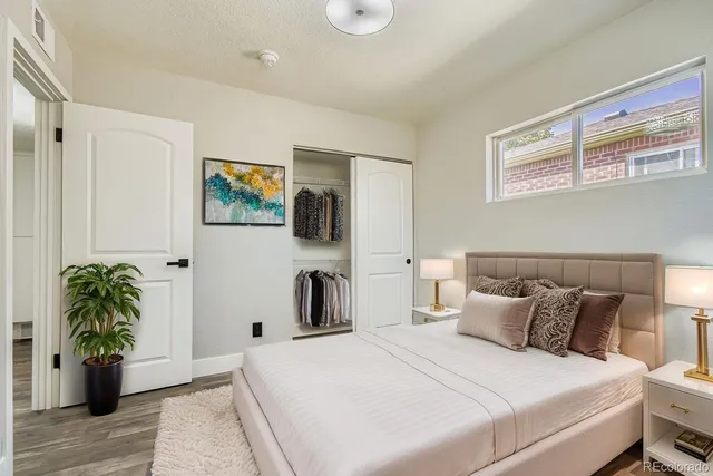 a bedroom with a bed and potted plant
