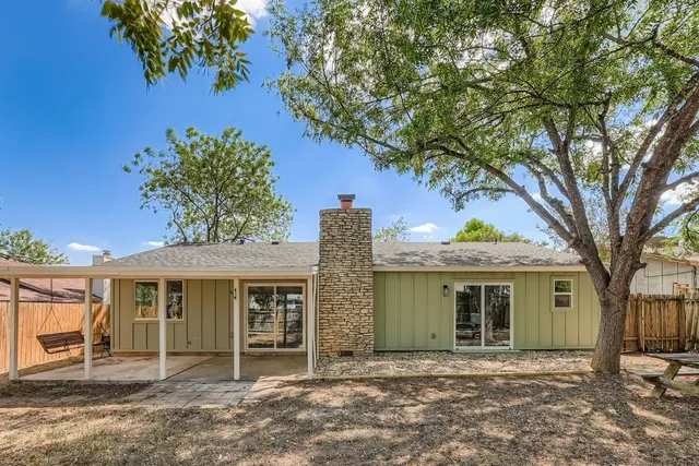 front view of a house with a tree