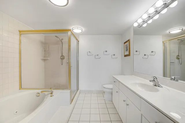 a bathroom with a double vanity sink toilet and shower