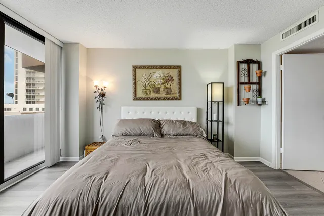 a bedroom with a large bed and a window