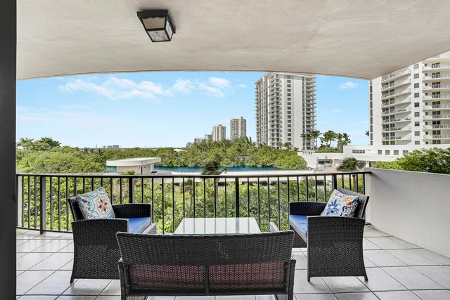 a view of a balcony with two chairs and a table