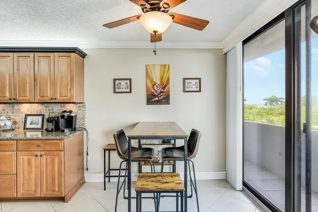 a view of a dining room with furniture and a window