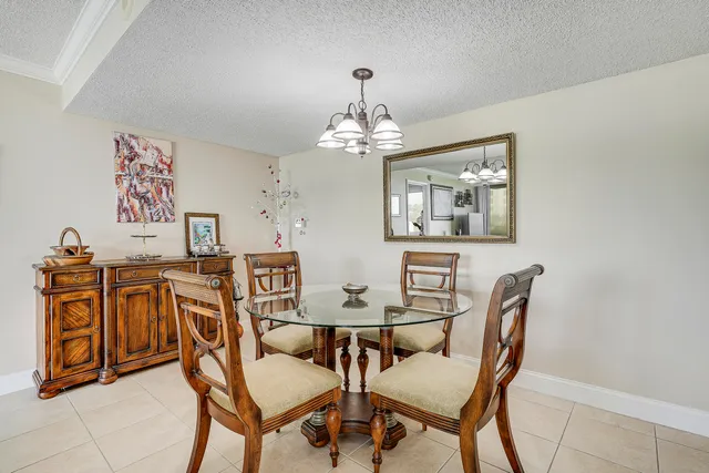 a view of a dining room with furniture and a chandelier
