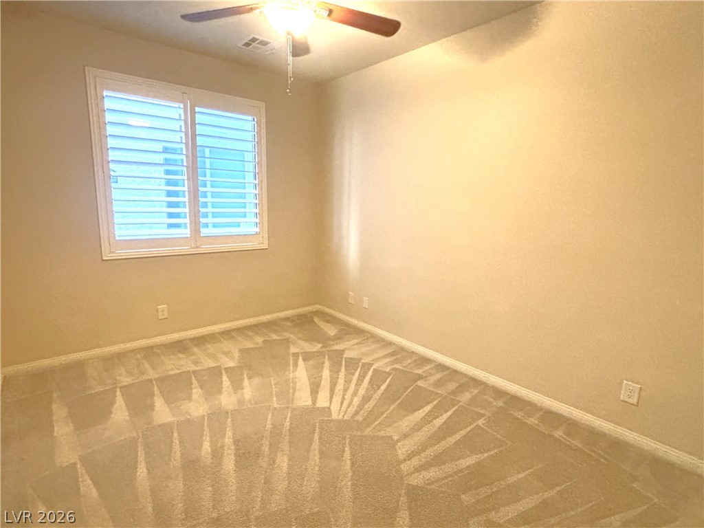 121 Elm Reed Avenue Las Vegas, NV 89113 - Photo 12 of 30 A well-lit bedroom features plush carpeting and custom window shutters.