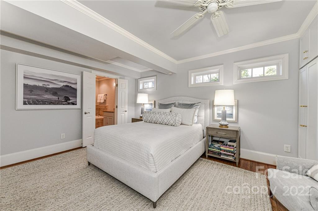 2700 Normandy Road Charlotte, NC 28209 - Photo 24 of 42 a bedroom with a large bed and a chandelier