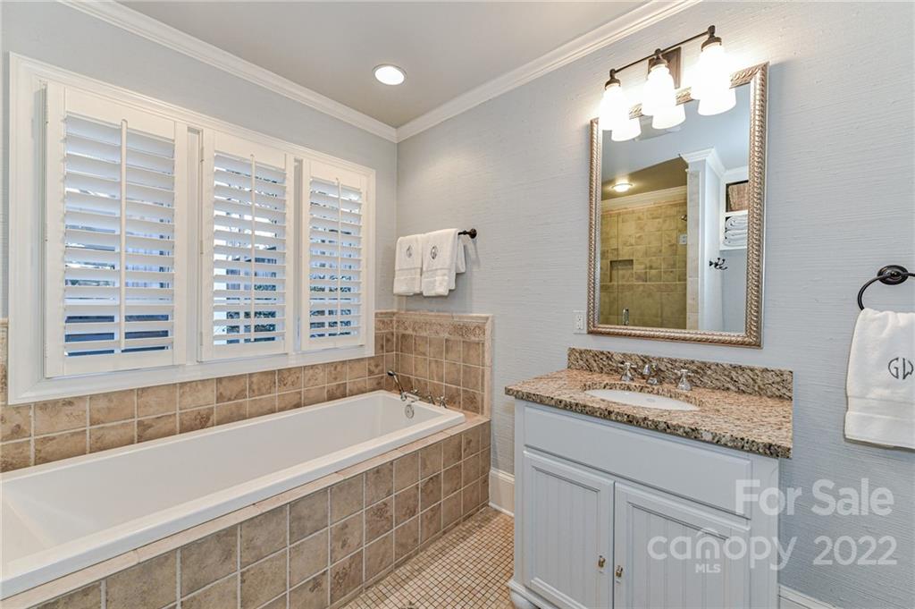 2700 Normandy Road Charlotte, NC 28209 - Photo 26 of 42 a bathroom with a tub sink and mirror