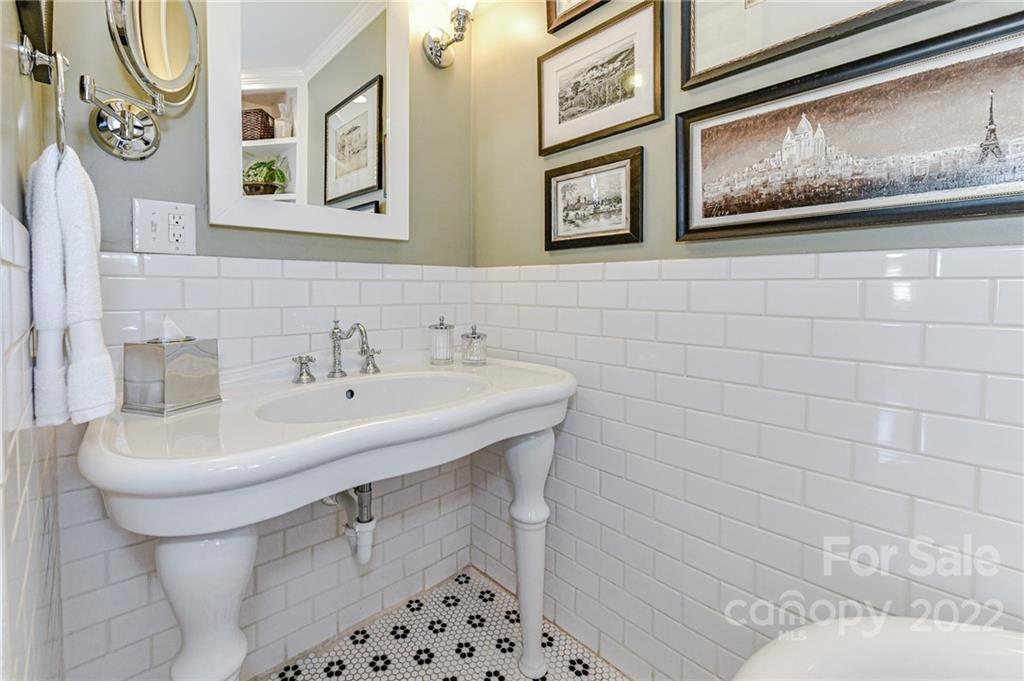 2700 Normandy Road Charlotte, NC 28209 - Photo 31 of 42 a bathroom with a sink a mirror and a toilet