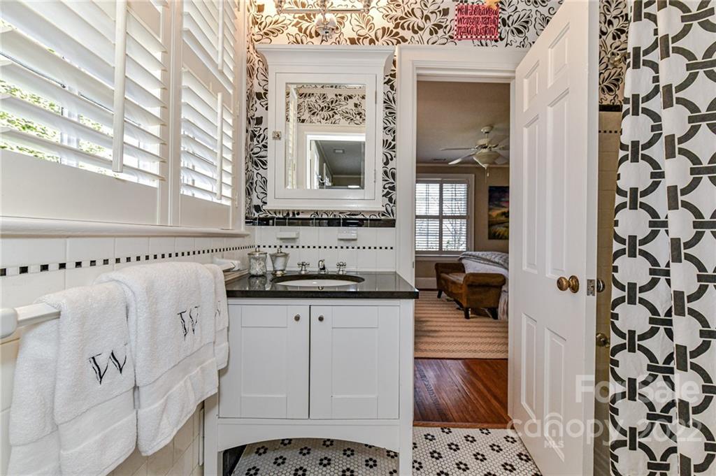 2700 Normandy Road Charlotte, NC 28209 - Photo 34 of 42 a bathroom with a sink a mirror and a bathtub