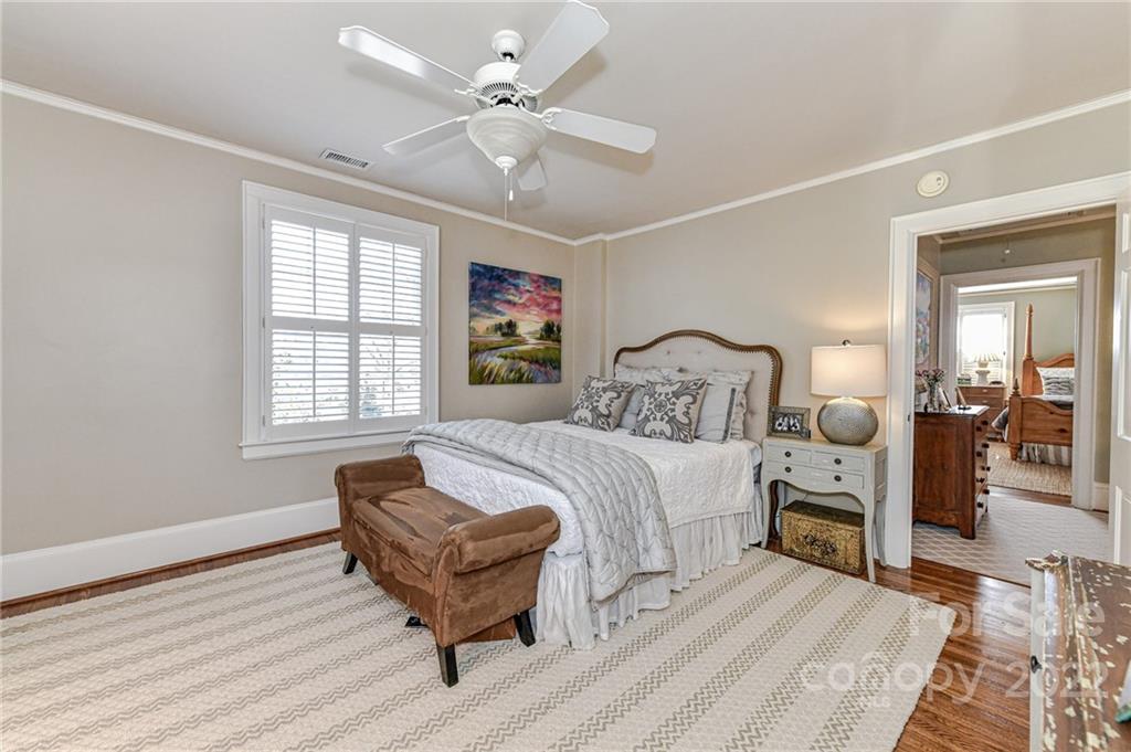 2700 Normandy Road Charlotte, NC 28209 - Photo 35 of 42 a bedroom with a bed wooden floor and window