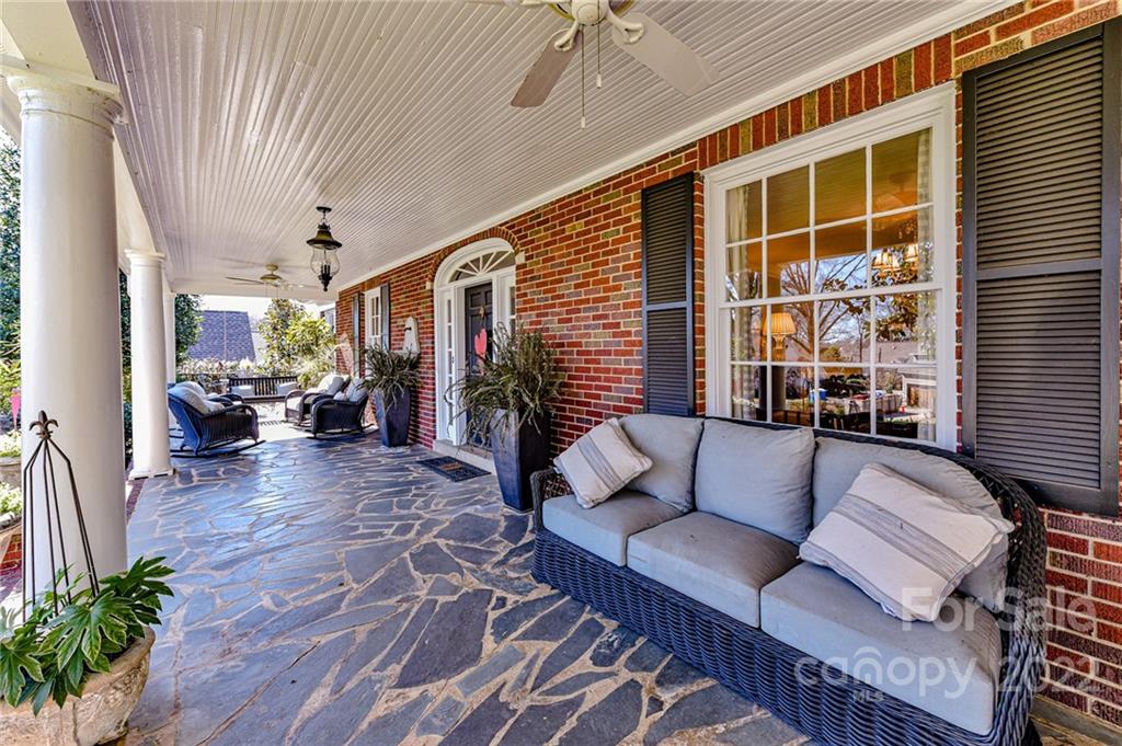 2700 Normandy Road Charlotte, NC 28209 - Photo 5 of 42 a balcony with furniture and a potted plant