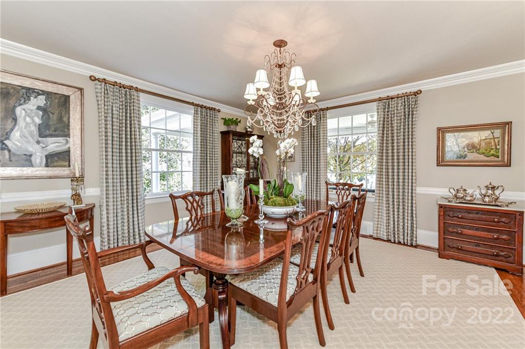 2700 Normandy Road Charlotte, NC 28209 - Photo 10 of 42 a dining room with furniture a chandelier and wooden floor