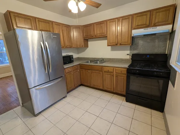 a kitchen with stainless steel appliances granite countertop a refrigerator stove and sink