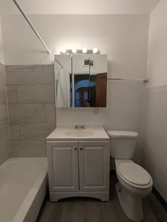 a bathroom with a sink a toilet and bathtub