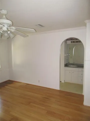 a view of empty room with wooden floor