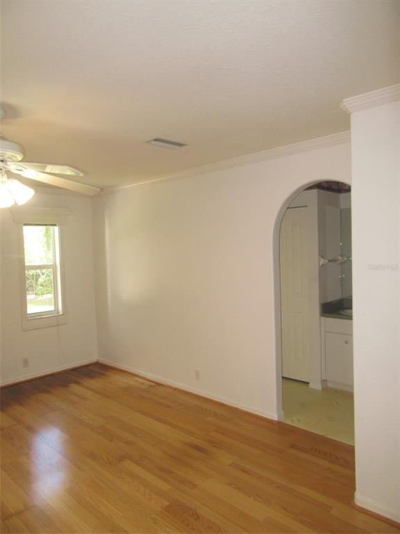 3632 Annapolis Terrace North Port, FL 34287 - Photo 8 of 14 an empty room with wooden floor and windows