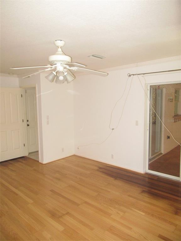 3632 Annapolis Terrace North Port, FL 34287 - Photo 9 of 14 en empty room with wooden floor fan and window