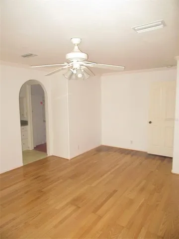 a view of a big room with chandelier fan