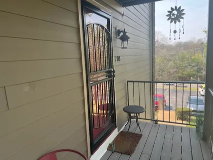 a view of a balcony with furniture