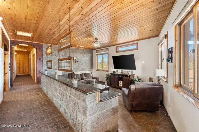 a spacious bedroom with a bed and wooden floor