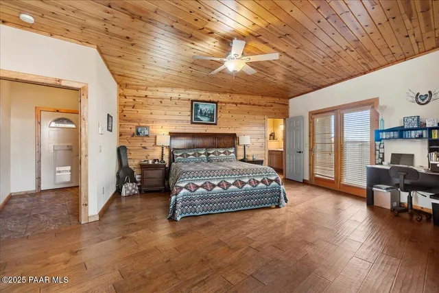 a bedroom with bed and a chandelier