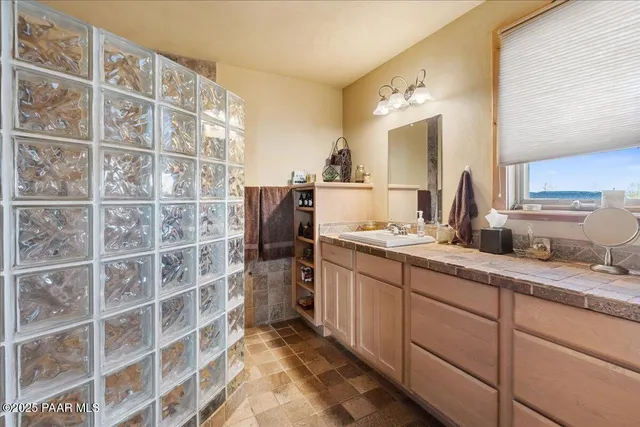 a bathroom with a sink double vanity granite and a mirror