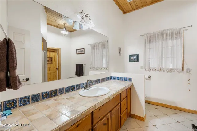 a view of a white house with a snow on the road