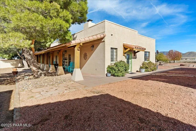 a view of a chairs and table in patio with a window