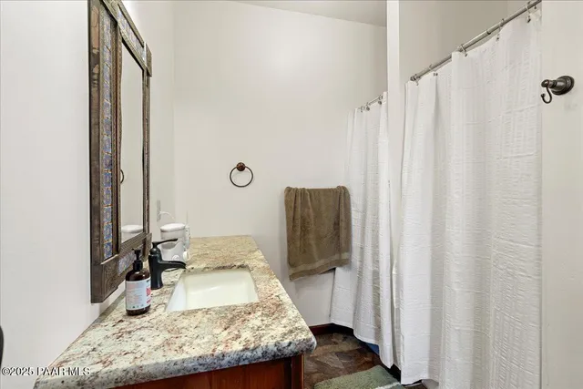 a balcony with table and chairs