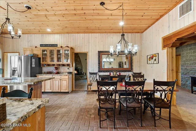 a view of a dining room with furniture and a chandelier