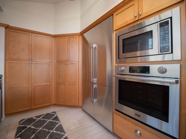 a bathroom with a granite countertop sink and a large mirror