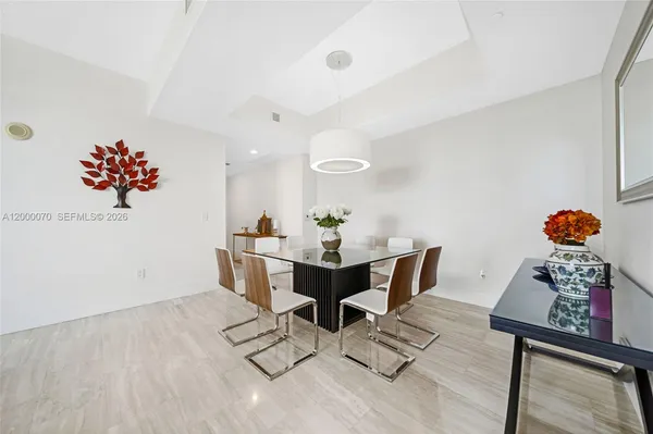 a view of a dining room with furniture wooden floor and a rug