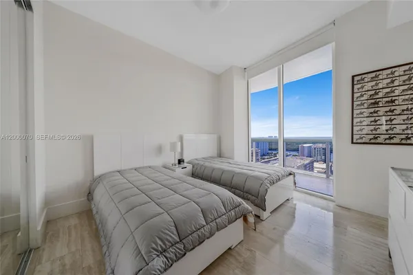 a bedroom with double bed and a window