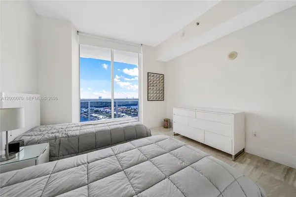 a bedroom with a bed and window