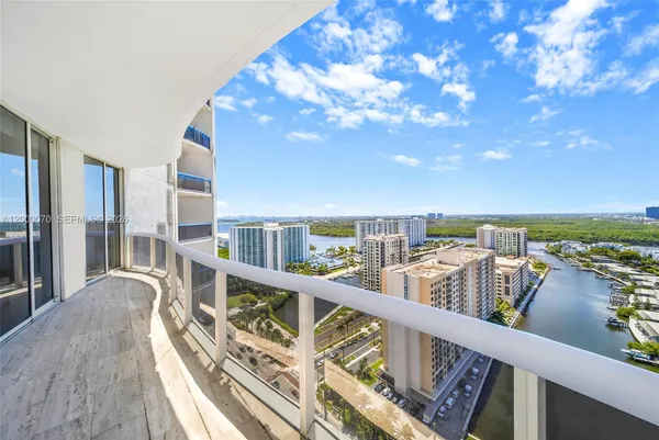a view of a balcony with wooden floor and city view