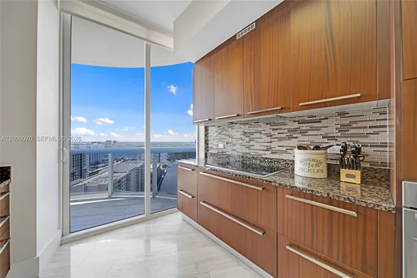 a kitchen with stainless steel appliances granite countertop a stove and a sink