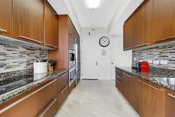 a kitchen with stainless steel appliances granite countertop a stove and a sink